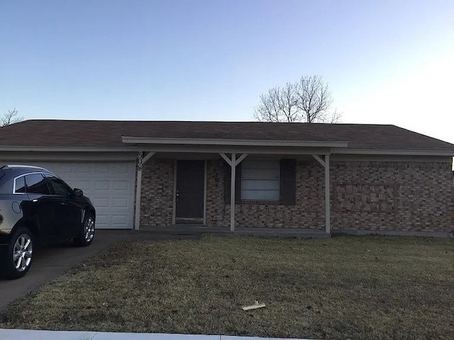 single story home featuring concrete driveway, brick siding, an attached garage, and a front yard