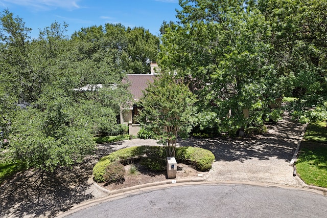 exterior space featuring driveway and a tiled roof