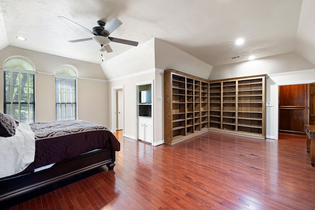 bedroom with visible vents, lofted ceiling, ceiling fan, wood finished floors, and a textured ceiling