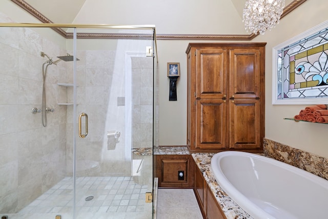 bathroom with a shower stall, an inviting chandelier, and a bath