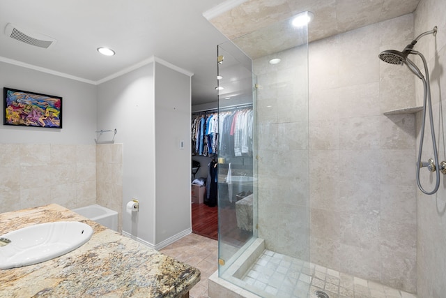 full bathroom featuring crown molding, visible vents, a spacious closet, a shower stall, and tile patterned floors