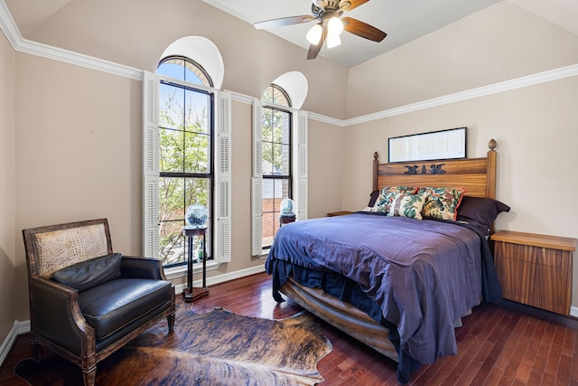 bedroom with dark wood-style floors, crown molding, lofted ceiling, a ceiling fan, and baseboards