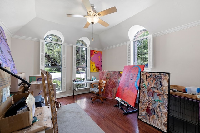 interior space featuring a ceiling fan, vaulted ceiling, wood finished floors, and ornamental molding