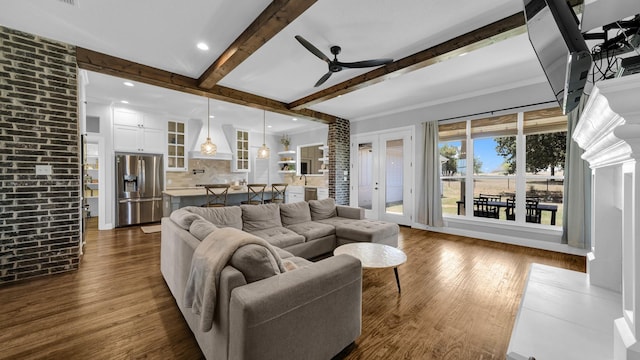 living area featuring recessed lighting, dark wood finished floors, beam ceiling, and a ceiling fan