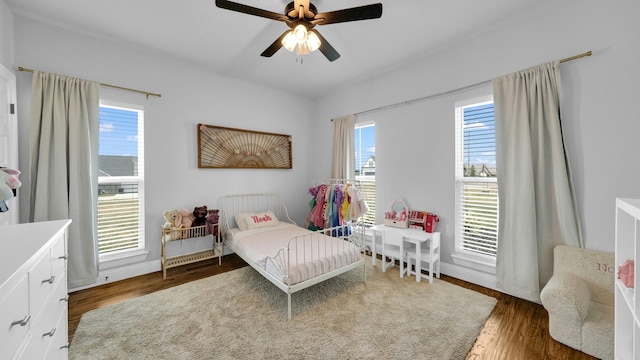 bedroom with ceiling fan and dark wood finished floors