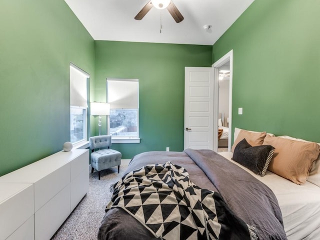 bedroom with a ceiling fan and light colored carpet