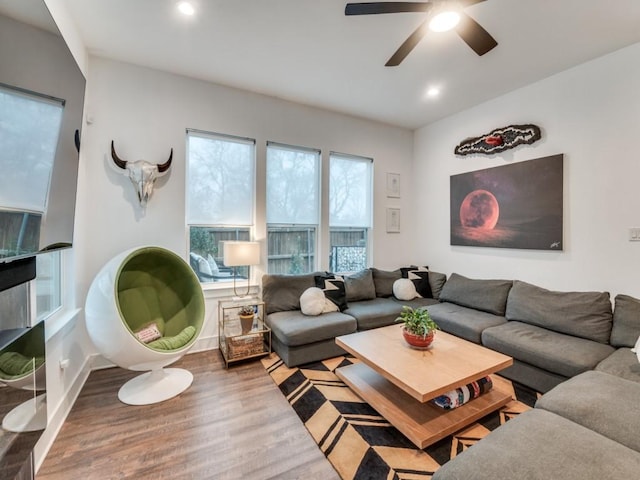 living room with a ceiling fan, recessed lighting, baseboards, and wood finished floors