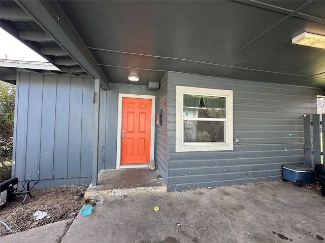 view of exterior entry with board and batten siding