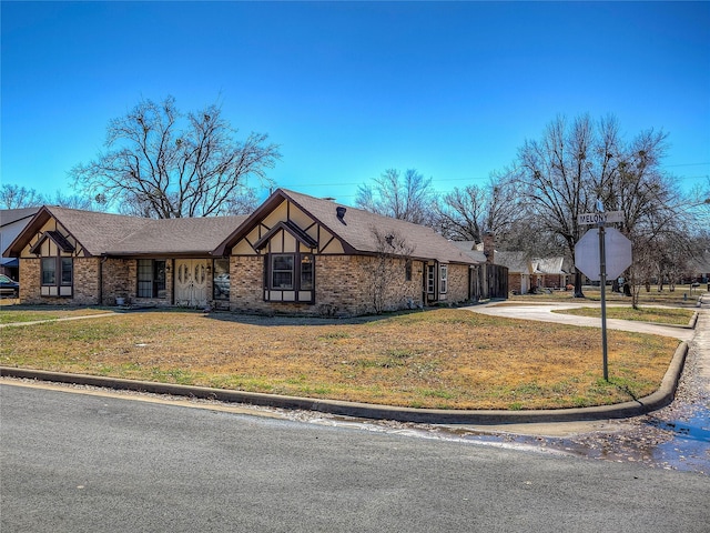 view of front of home with a front lawn and brick siding