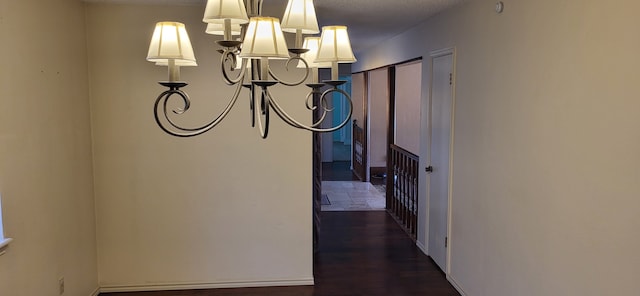 hall featuring dark wood-type flooring and a textured ceiling