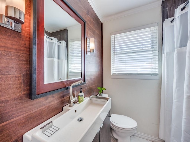 bathroom featuring toilet and crown molding