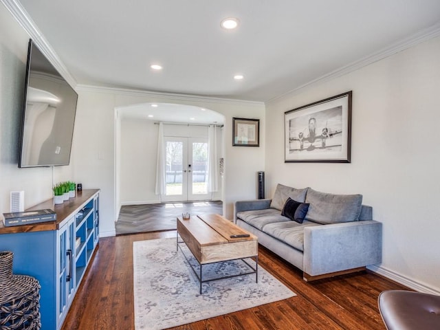 living room featuring arched walkways, french doors, dark wood finished floors, and crown molding