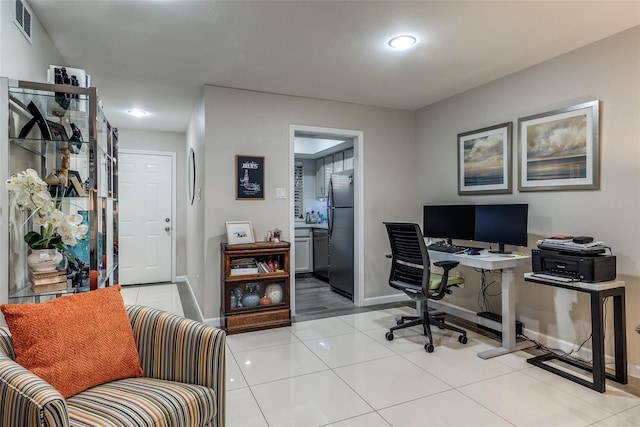 office space with light tile patterned floors, baseboards, and visible vents