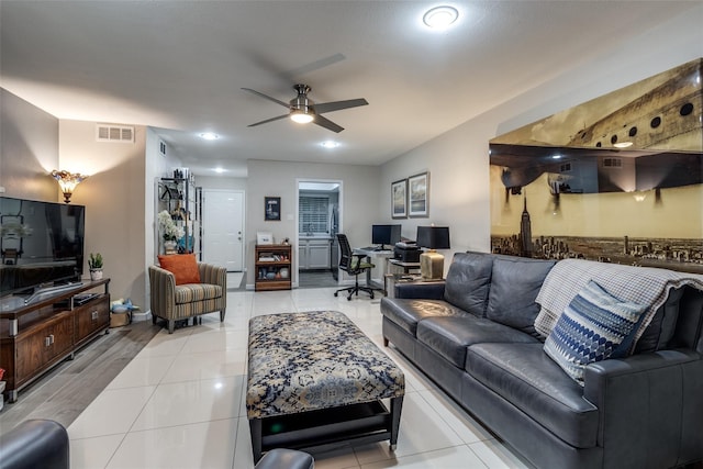 living room with visible vents, ceiling fan, and light tile patterned floors