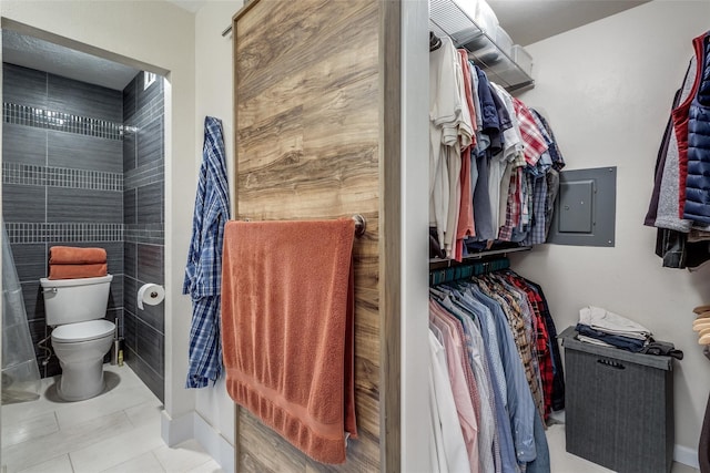 spacious closet with electric panel and light tile patterned floors