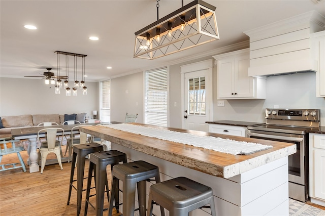 3147 US Highway 67, Sulphur Springs, TX 75482 - kitchen featuring electric stove, open floor plan, ornamental molding, white cabinets, and a center island