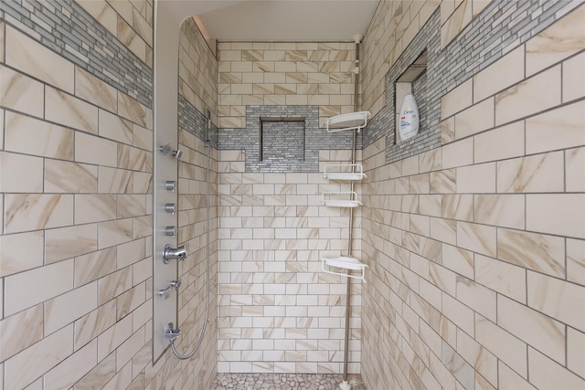 full bathroom featuring tiled shower