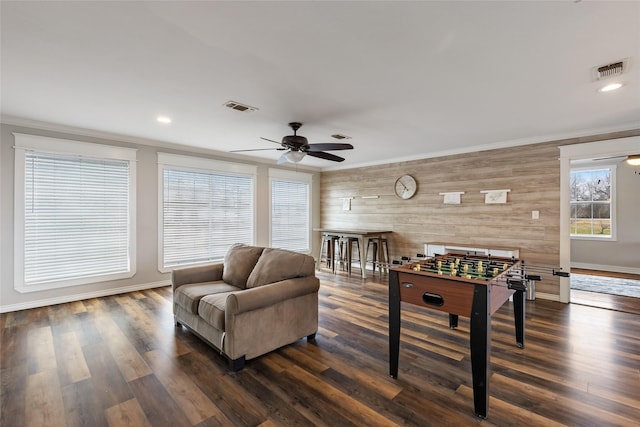 3147 US Highway 67, Sulphur Springs, TX 75482 - recreation room featuring wooden walls, crown molding, a ceiling fan, dark wood-type flooring, and baseboards