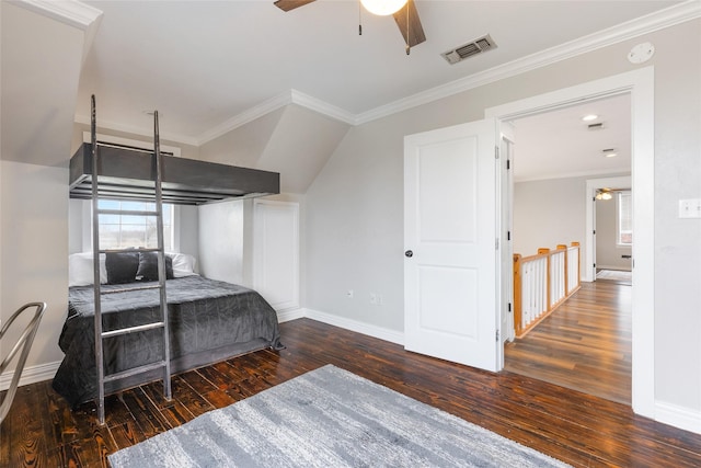 bedroom featuring baseboards, dark wood finished floors, visible vents, and crown molding