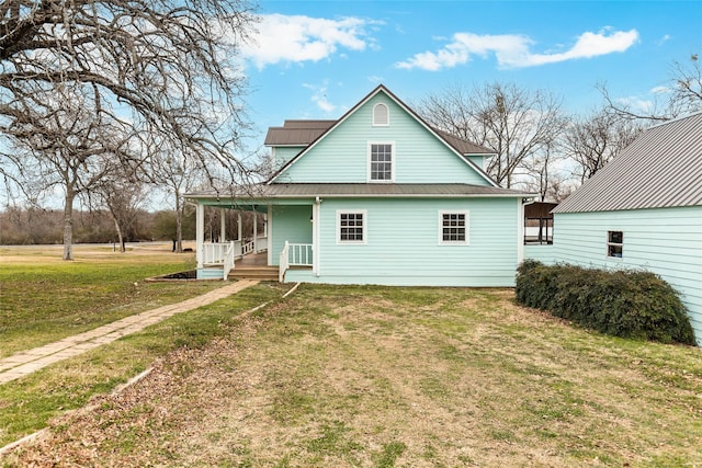 exterior space with a porch, metal roof, and a lawn