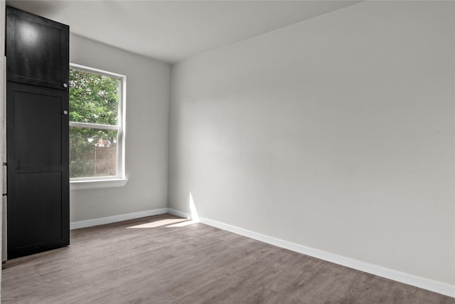 empty room featuring light wood-style flooring and baseboards