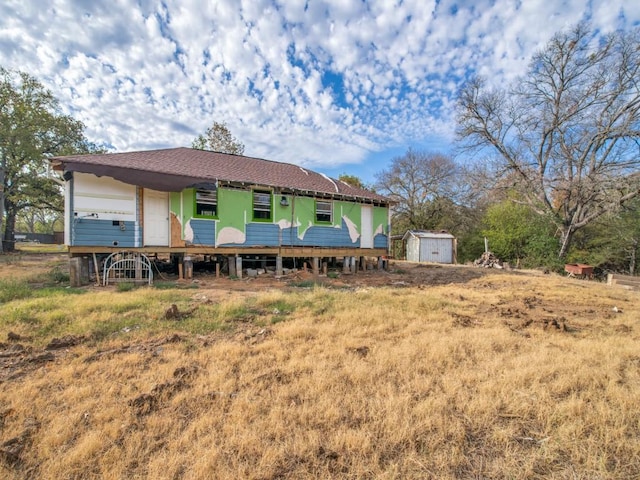 225 Lake Dr, Hickory Creek, TX 75065 - rear view of property with a storage shed and an outdoor structure