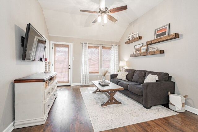 living area with ceiling fan, baseboards, vaulted ceiling, and dark wood finished floors