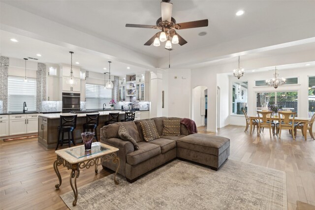 kitchen featuring a sink, a center island, decorative backsplash, and freestanding refrigerator