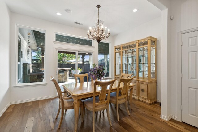 kitchen with arched walkways, tasteful backsplash, black appliances, beverage cooler, and hardwood / wood-style floors