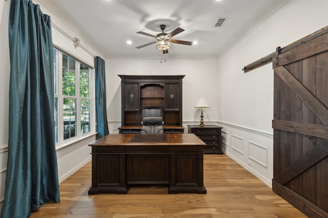 office featuring visible vents, crown molding, ceiling fan, and light wood-type flooring