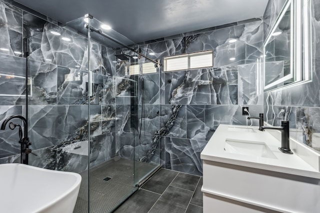 full bath with a soaking tub, a sink, tile walls, and a marble finish shower