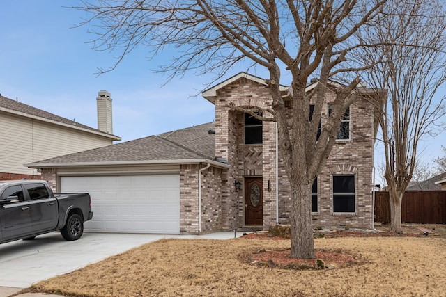 traditional-style house with a garage, a shingled roof, concrete driveway, and brick siding