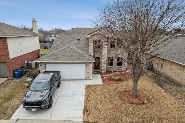 traditional home featuring concrete driveway, roof with shingles, an attached garage, cooling unit, and brick siding