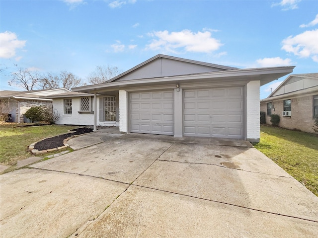 ranch-style home featuring a garage, concrete driveway, and a front yard