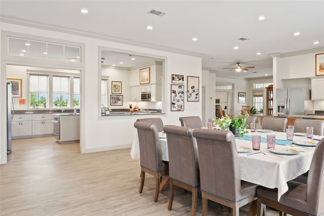 dining room featuring recessed lighting, visible vents, crown molding, and light wood finished floors