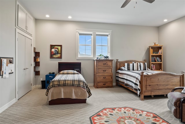 bedroom featuring a ceiling fan, recessed lighting, light colored carpet, and baseboards