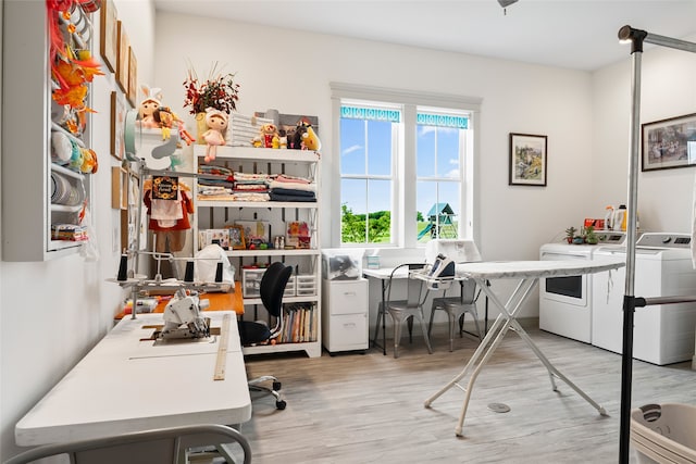 home office featuring washing machine and dryer and light wood-style flooring