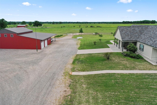 exterior space with driveway and a rural view