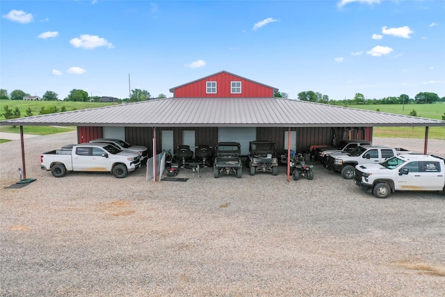 view of parking with a pole building and a carport