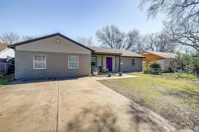 ranch-style home with a front lawn and brick siding