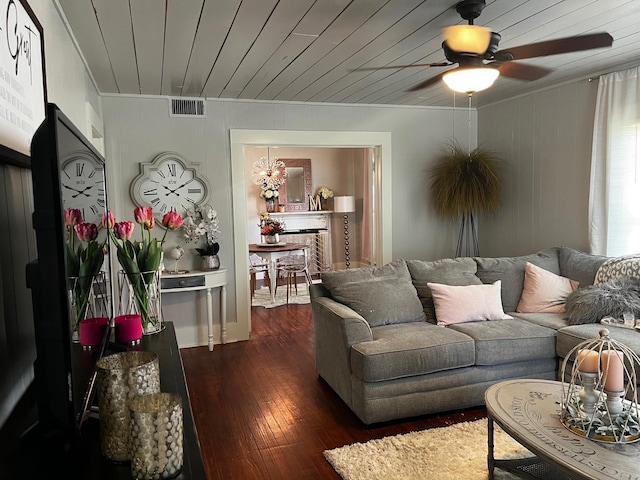 living room with visible vents, dark wood finished floors, a ceiling fan, wooden ceiling, and crown molding