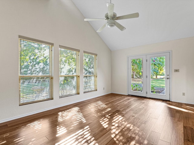 unfurnished room with high vaulted ceiling, a ceiling fan, baseboards, and wood finished floors