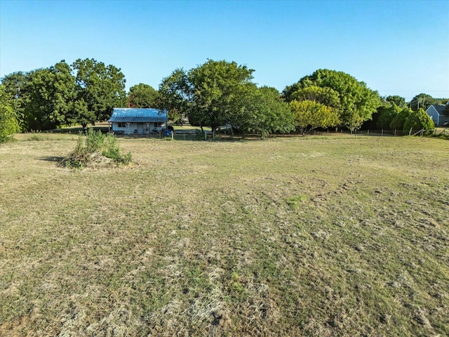 view of yard featuring a rural view and fence