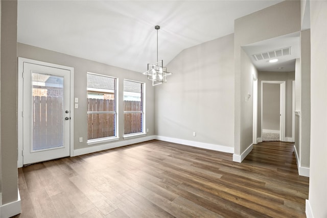 unfurnished dining area featuring vaulted ceiling, visible vents, dark wood finished floors, and baseboards