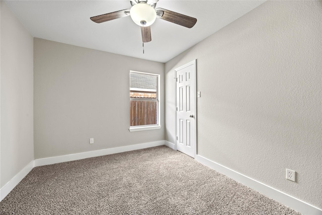 empty room with ceiling fan, baseboards, and carpet flooring