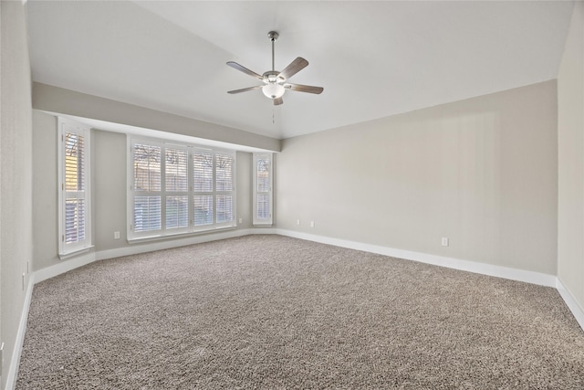 empty room with carpet, ceiling fan, and baseboards