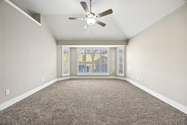 carpeted spare room with a ceiling fan, lofted ceiling, and baseboards