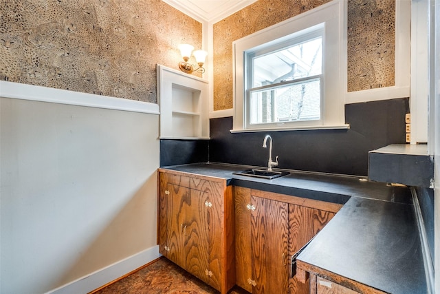 interior space with crown molding, vanity, and baseboards