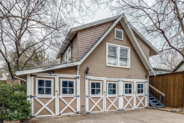 exterior space featuring an outdoor structure and fence