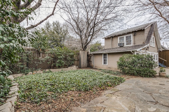 view of yard featuring a patio area, fence, and cooling unit